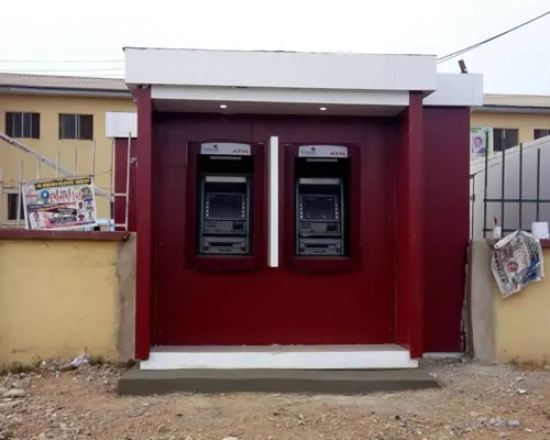 Red twin ATM kiosk installed outside a building